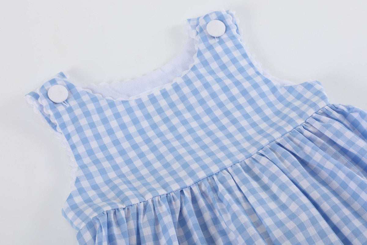Close-up of The Little Goose Dress shoulder buttons and gingham