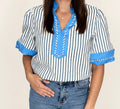 Close-up of The Hadley Stripe Top, blue and white stripes with bright blue V-neck trim