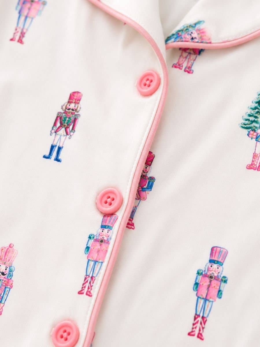 Close-up of the Sugar Plum Fairy pajama top with pink piping and buttons