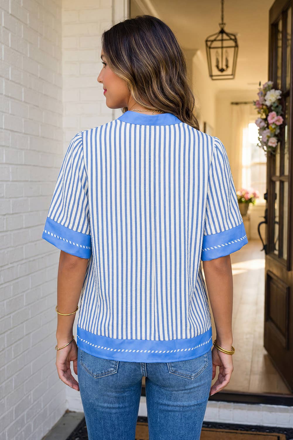 Back view of The Hadley Stripe Top in an entryway