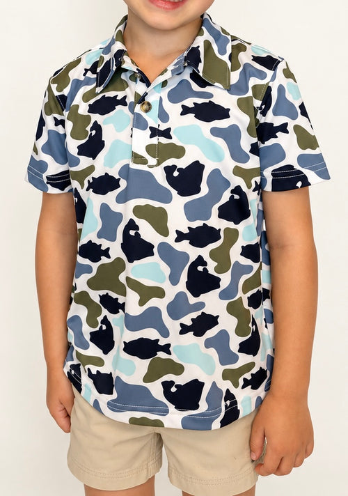 Boy wearing The Castaway Camo Polo with khaki shorts, front view