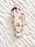 The Daydream Floral Tumbler, a cream 40 oz tumbler with pink and coral flowers and a blush flip straw