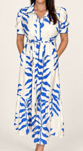 Woman wearing The Charleston Dress, ivory maxi dress with blue leaf print, front view
