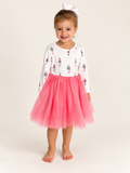 Girl wearing The Nutcracker Twirl Dress, ivory nutcracker bodice and pink tulle skirt